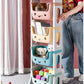Children's toy organizer with books and toys on a carpeted floor. NexTrend UAE Cash on Delivery